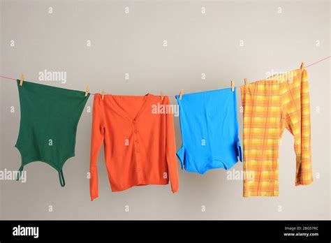 Laundry line with clothes on wall background Stock Photo - Alamy