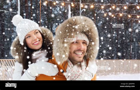 happy couple over ice skating rink background Stock Photo - Alamy