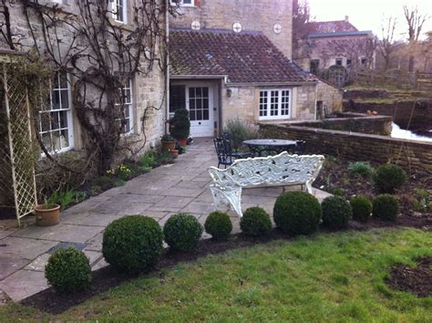 Buxus ball hedge to add structure and formality to the old mill house | Farmhouse exterior ...