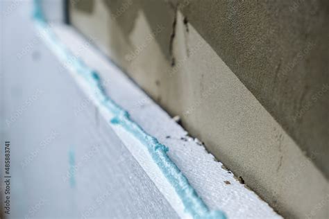 Installation of styrofoam insulation sheets on house facade wall for ...