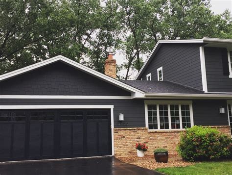 Black garage doors with white trim - Builders Villa