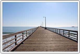 The Avila Beach Pier extends into the ocean from the Avila Promenade