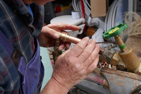 Installation of an Outdoor Faucet. Plumber during the Preparation Work To Install an Outdoor ...