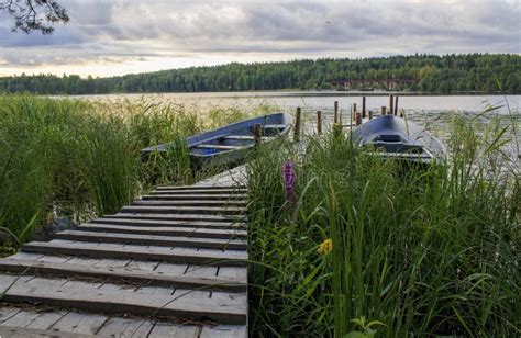 Old Boat Dock on a Lake on a Cloudy Morning on a Lake Stock Photo - Image of blue, boat: 140310036