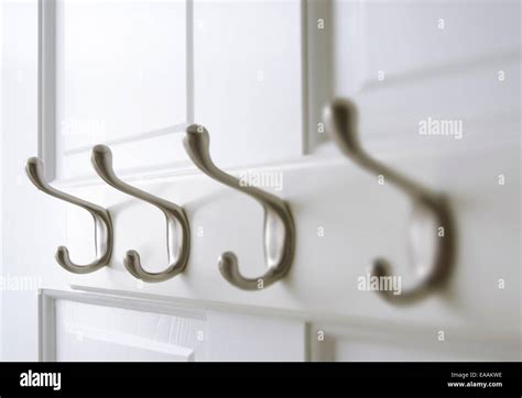 Chrome coat hooks are mounted on the back of a closet door Stock Photo - Alamy