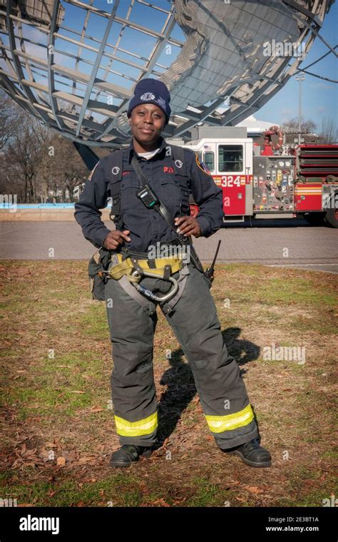 An attractive woman firefighter in uniform at Flushing Meadows Corona Park in Queens, New York ...