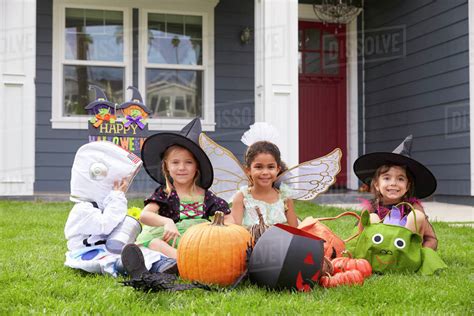 Children Dressed In Trick Or Treating Costumes On Lawn - Stock Photo ...