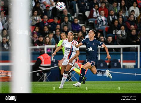 Lyon’s French forward Delphine Cascarino (R) fights for the ball with ...