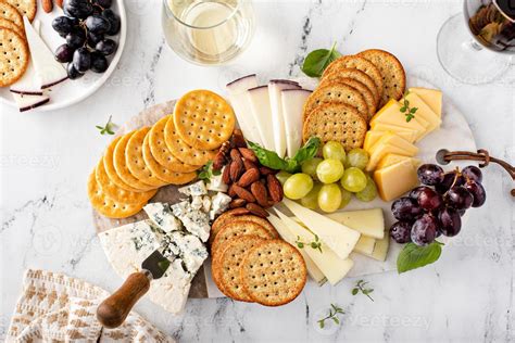 Cheese board with crackers, nuts and grapes 16228999 Stock Photo at Vecteezy