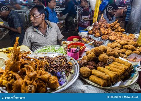 KHULNA, BANGLADESH - NOVEMBER 12, 2016: Street Food Seller at a Market in Khulna, Banglade ...