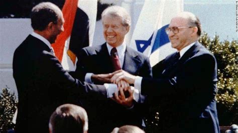 The triple handshake between Egyptian President Anwar Sadat on the left ...