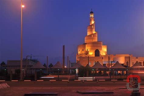 a large building with a clock tower lit up at night