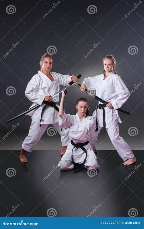 Beautiful Young Female Karate Players Posing with Sword on the Gray Background Stock Photo ...