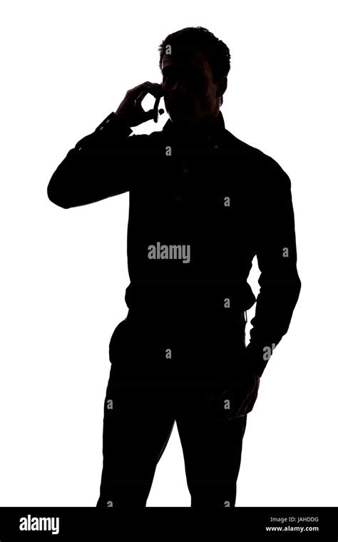 Man talking on cell phone in silhouette isolated over white background ...