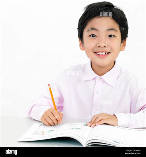 a boy studying hard in class Stock Photo - Alamy