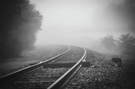 Train tracks on foggy morning-Black and White Photograph by Maxwell Dziku