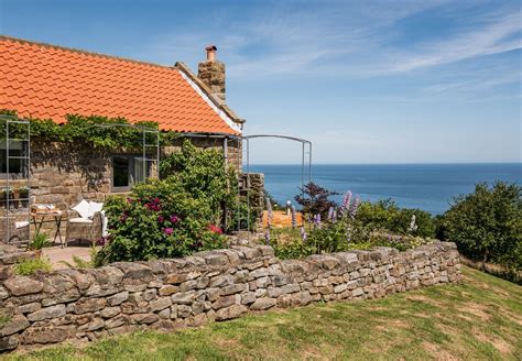 Nestled on the cliffs overlooking picturesque Robin Hood's Bay, this luxury coastal cottage for ...