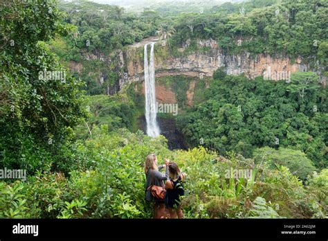 Mauritius tourism; tourists looking at the Chamarel waterfalls, Chamarel Mauritius in the Black ...