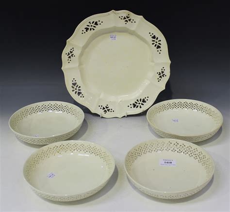 A set of four creamware circular bowls, early 19th Century, each with pierced band to rim, diameter