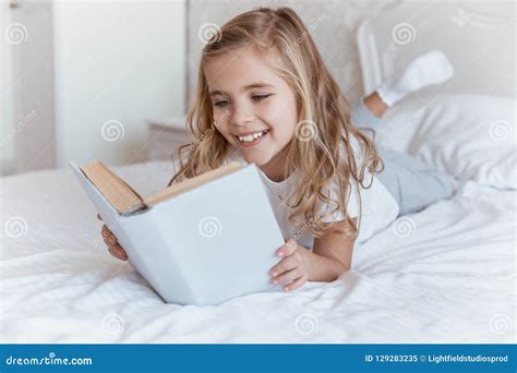 Smiling Kid Lying on Bed and Reading Stock Image - Image of happy ...