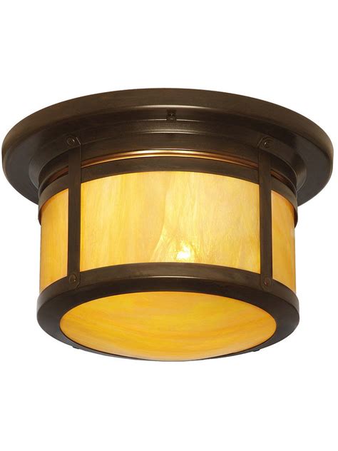 a light fixture with a yellow shade on it