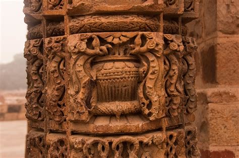 A Stone Pillar With Beautiful Carvings Inside The Qutub Minar Complex ...