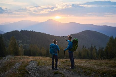 Free Photo | Summer mountain trekking Two travelers hiking in the mountains