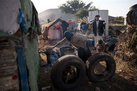 Shuyeh Ali Ammar, 35, cooking for her family in a camp for internally ...