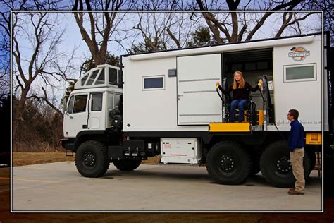 a woman standing in the open door of a truck