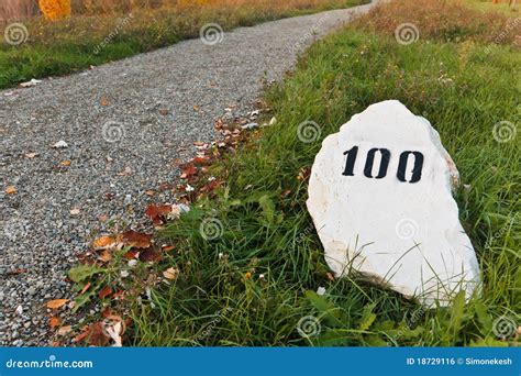 Mile Stone in the Grass Near the Road Stock Photo - Image of white, road: 18729116