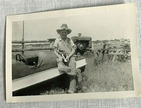 1940s Farmer Boy With Pet Skunk Seated on Boat With Old Tractor in ...