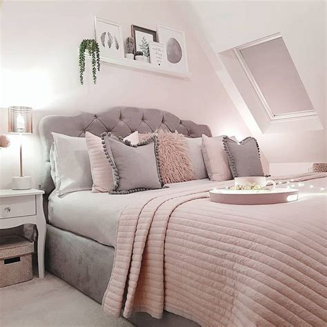 a bedroom with white walls and pink bedding