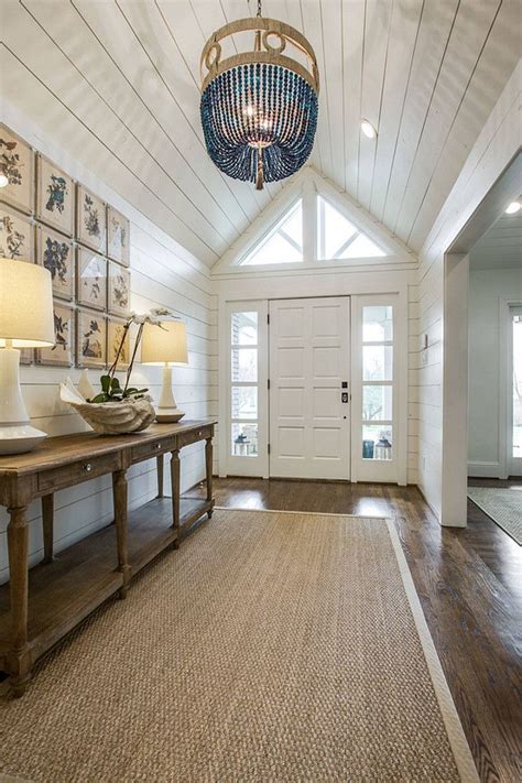 coastal inspired foyer/hallway with shiplap, planked ceilings/walls ...