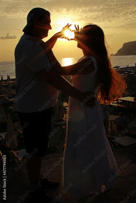 silhouette of couple at sunset Stock Photo | Adobe Stock