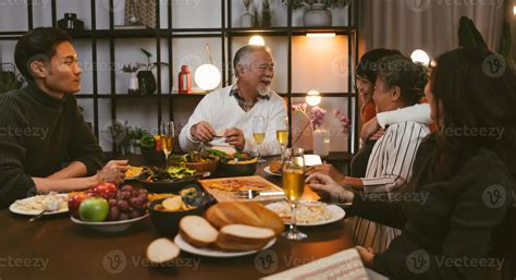 Asian family having dinner at dining table at home 10209929 Stock Photo at Vecteezy