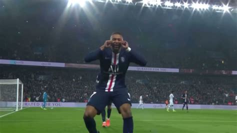 a man standing on top of a soccer field holding his hands up to his face