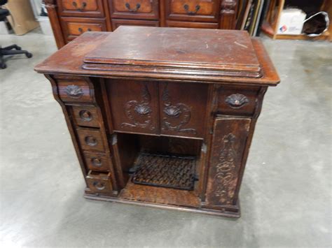 VINTAGE TREADLE BASE SINGER SEWING MACHINE IN CARVED CABINET - Big Valley Auction