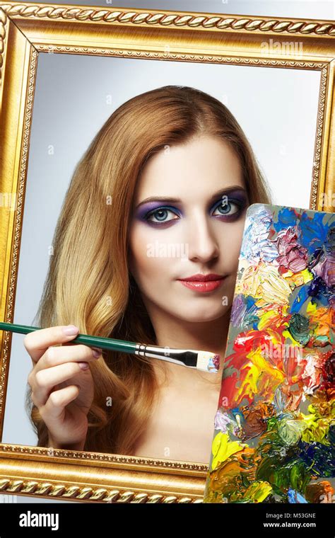 Young woman painter in golden frame with color palette and paint brush in hand Stock Photo - Alamy