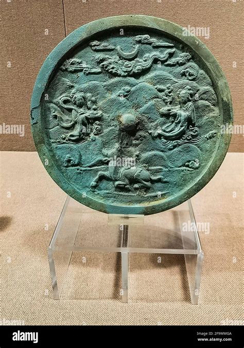 XIANGYANG, CHINA - APRIL 16, 2021 - The bronze mirror of the story of the golden Wu ox watching ...