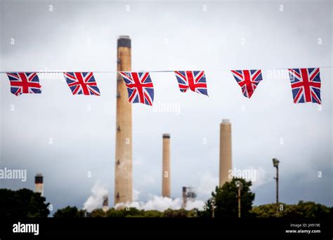 Refinery chimneys with Union Jack bunting flags in the foreground Stock ...