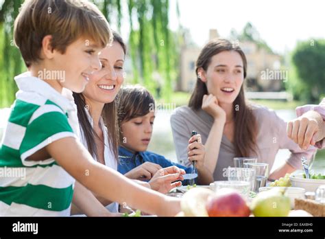 Family eating together outdoors Stock Photo - Alamy