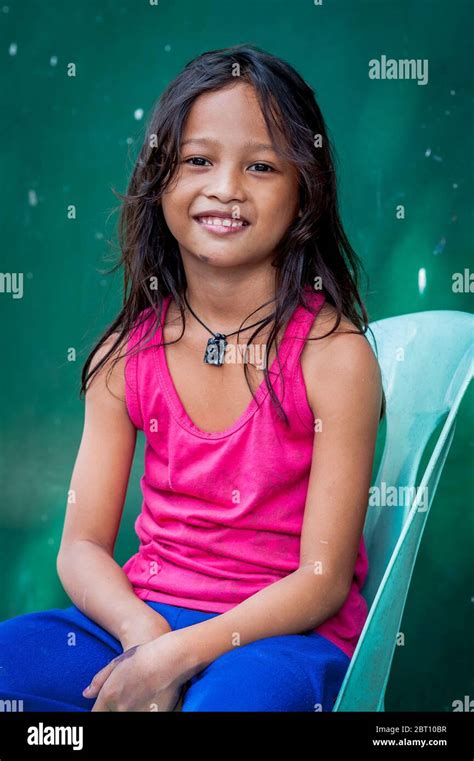 A pretty young Filipino girl poses and smiles for my camera in the old ...