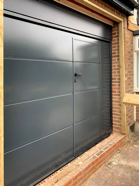 A Hormann LPU42 L-Ribbed Sectional Garage Door + Wicket Door finished ...