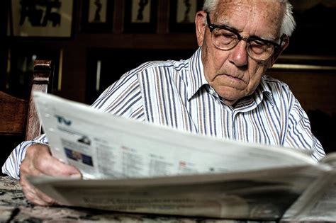 Elderly Man Reading A Newspaper Photograph by Mauro Fermariello - Fine Art America