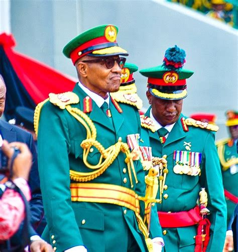 PICTORIAL: Buhari arrives army parade in military uniform