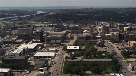 5.7K stock footage aerial video flying by 5th Street between office buildings and hospital ...