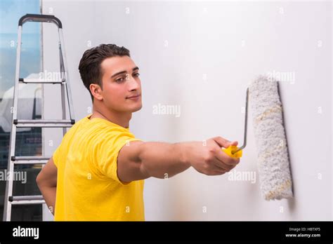 Man painting house in DIY concept Stock Photo - Alamy