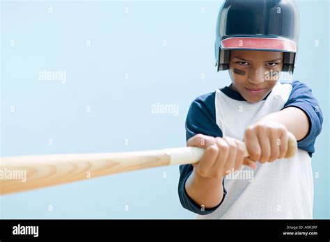 Boy swinging baseball bat Stock Photo - Alamy