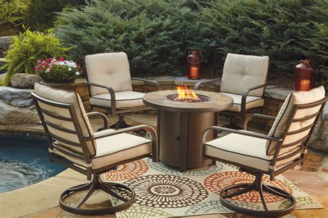 Predmore Beige and Brown Outdoor Round Fire Pit Table from Ashley | Coleman Furniture