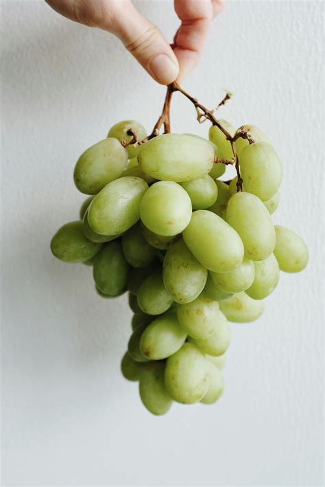 Green Grapes on White Surface · Free Stock Photo